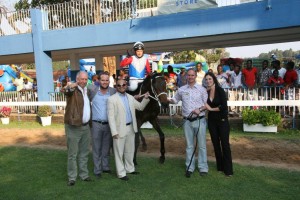 : Will Pays is led in after winning at Borrowdale by connections, including Gareth Pepper (second from left).