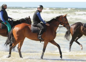 Jockey Corne Offer takes Alexis for a stroll on the beach. (Picture: Liesl King)