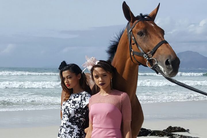 Callie-Jo Bouman and Chante Holloway, two semifinalists in this year’s Miss SA, pose with Sun Met celebrated with GH Mumm hopeful Captain America on the beach.